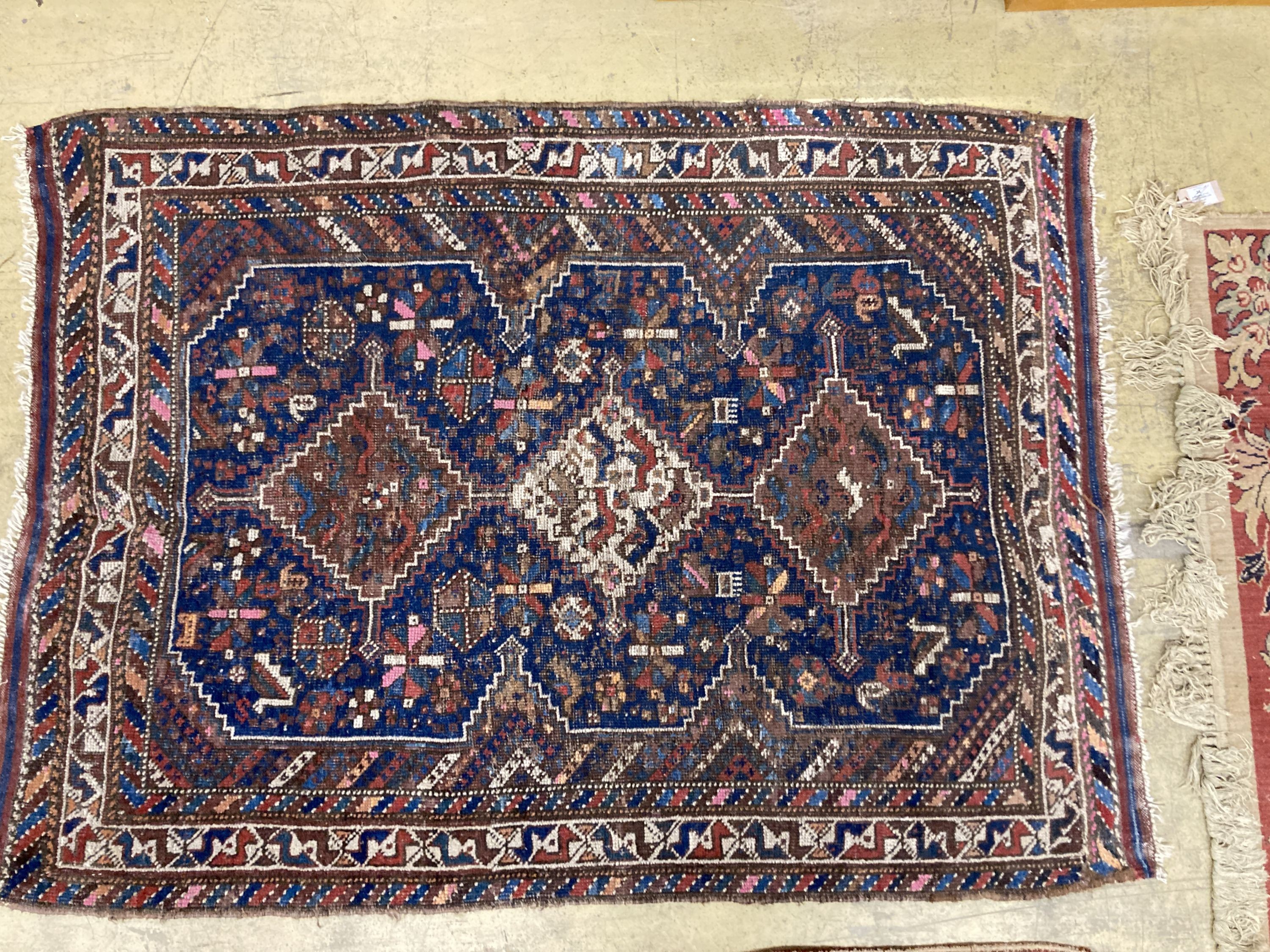 Three antique Caucasian blue ground rugs, largest 154 x 114 cms.